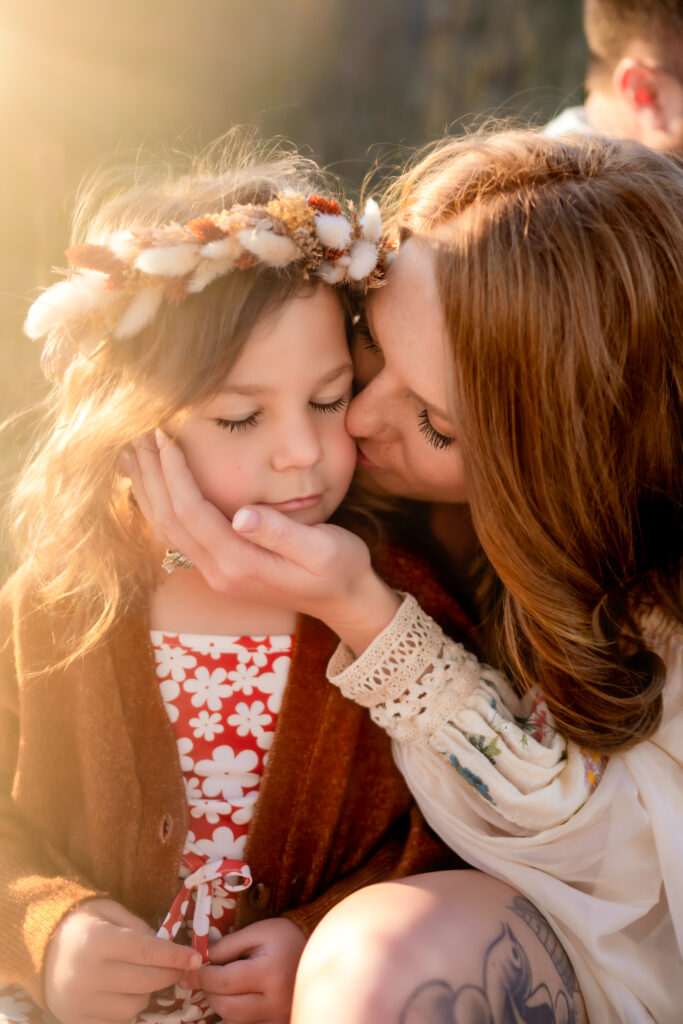 mother kissing daughters cheek