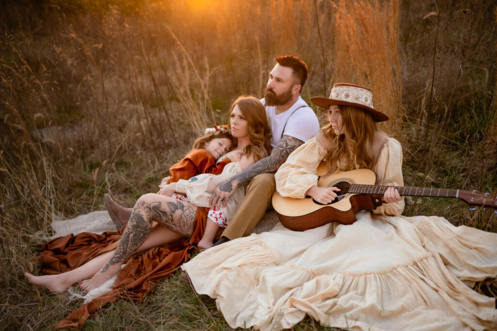 family snuggled up in the grass